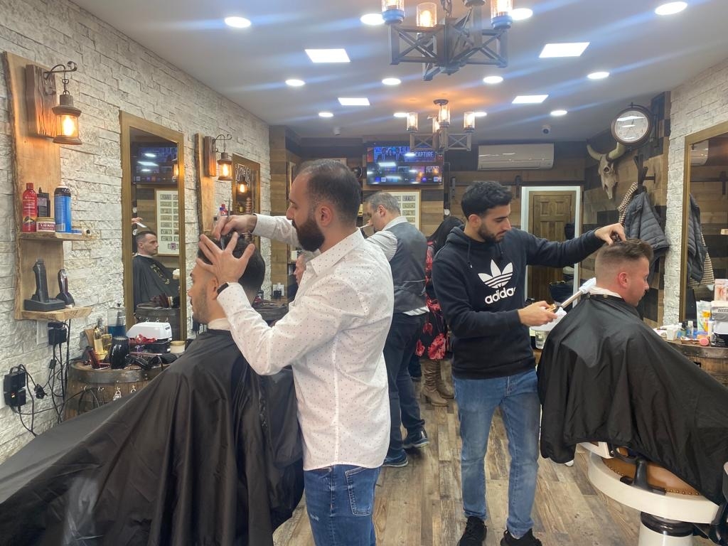 What types of services are typically offered at high-end men's grooming boutiques?