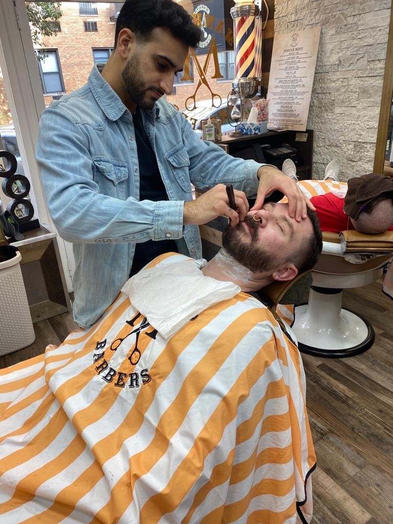 What are the different types of haircuts offered at men's grooming salons in NYC?