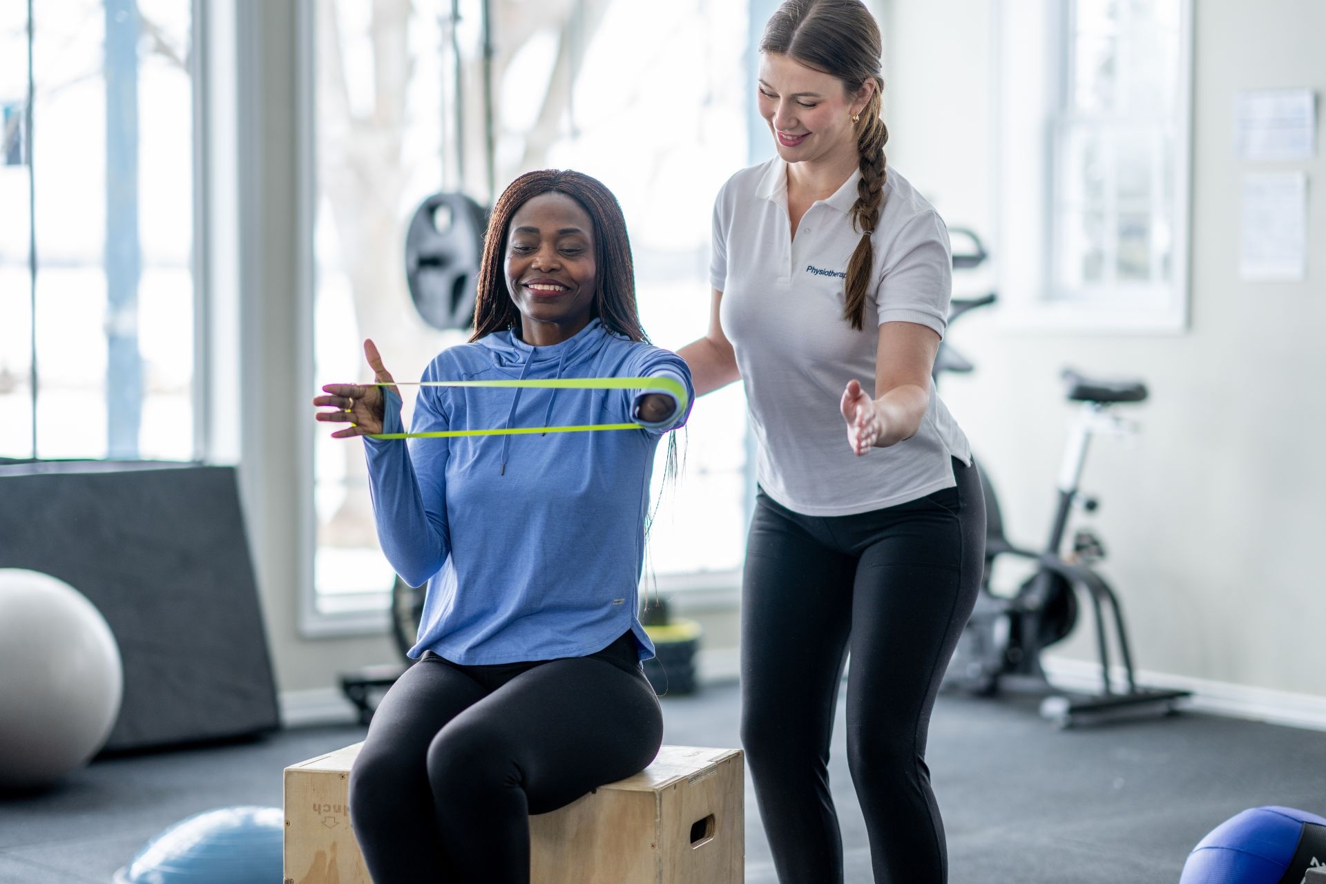 How often should the spring tension on a mini trampoline be checked and adjusted?